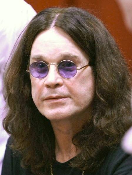 Portrait of Ozzy Osbourne wearing round purple-tinted glasses